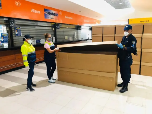 Employees with a donation of cardboard coffins in Guayaquil, Ecuador on April 5, 2020