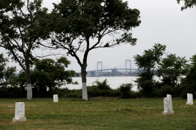 Stones mark mass graves on Hart Island, the former location of a prison and hospital that is a potter"s field burial site of as many as one million people, in New York, United States, June 23, 2016