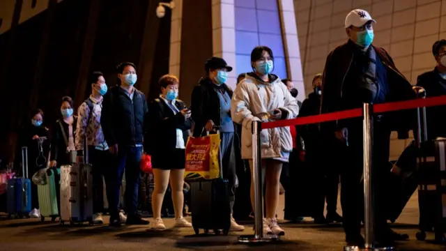 People queue outside Wuhan Wuchang Railway Station