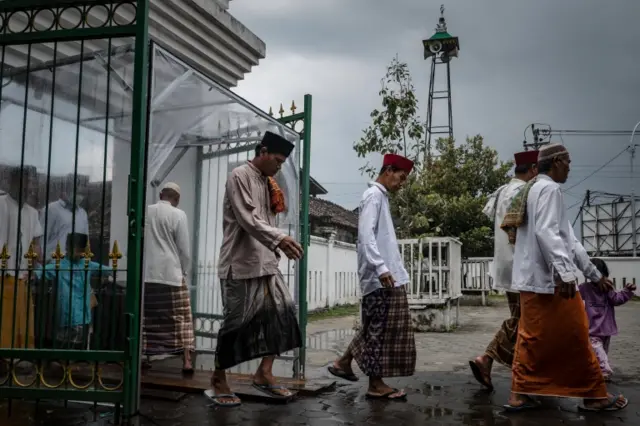 Muslims walk through disinfectant chamber at Jakarta mosque - 3 April