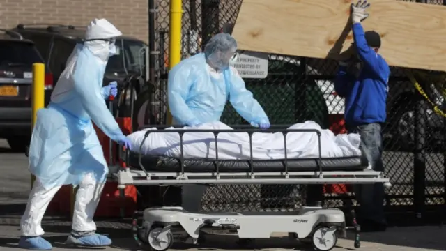 Medics with a coronavirus victim in a body bag