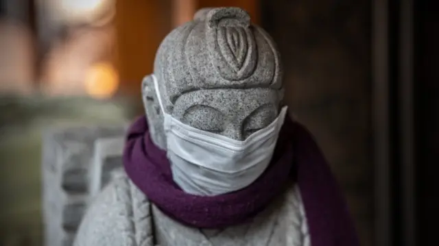 Masked statue outside a Tokyo restaurant