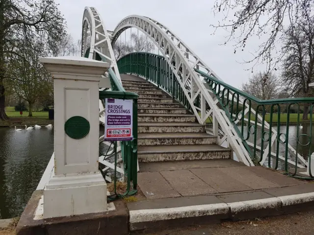 Sign by a bridge