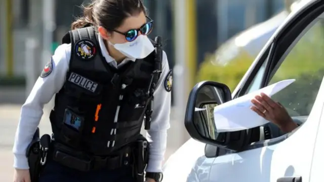 French police offer wearing a mask