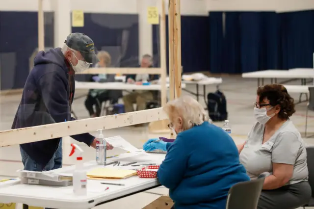 Plexiglass protectors have been erected to keep the public from interacting with poll workers