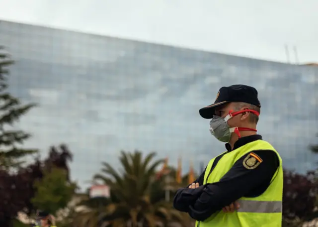 Policeman at a traffic control post stops drivers in Huesca, Spain