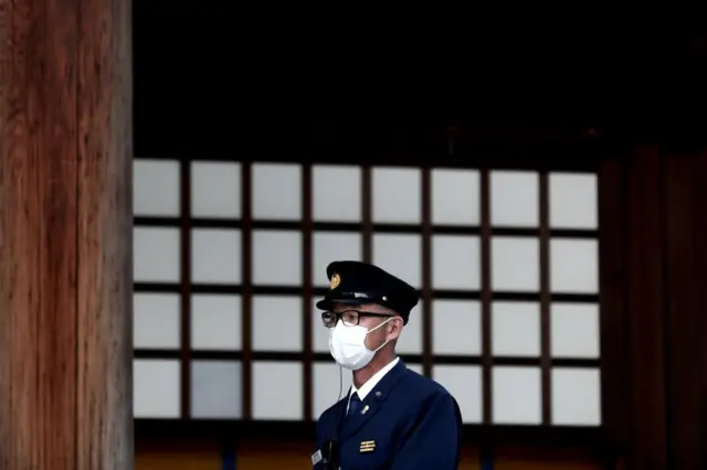 A security guard wearing a face mask