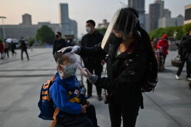 People wearing masks and face shields at Wuhan railway station