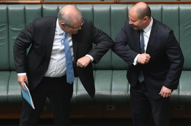 Prime Minister Scott Morrison and Treasurer Josh Frydenberg bump elbows in greeting each other