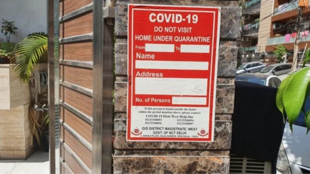 Warning stickers posted outside a home of someone who is in quarantine