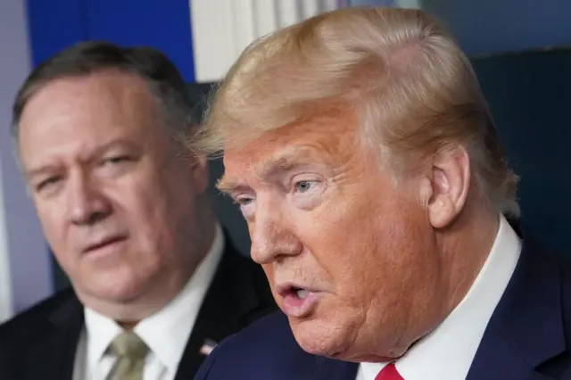 US Secretary of States Mike Pompeo listens as US President Donald Trump speaks during the daily briefing on the novel coronavirus