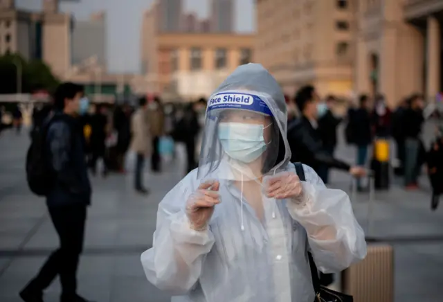 A person wearing a face mask arrives at Hankou Railway Station in Wuhan