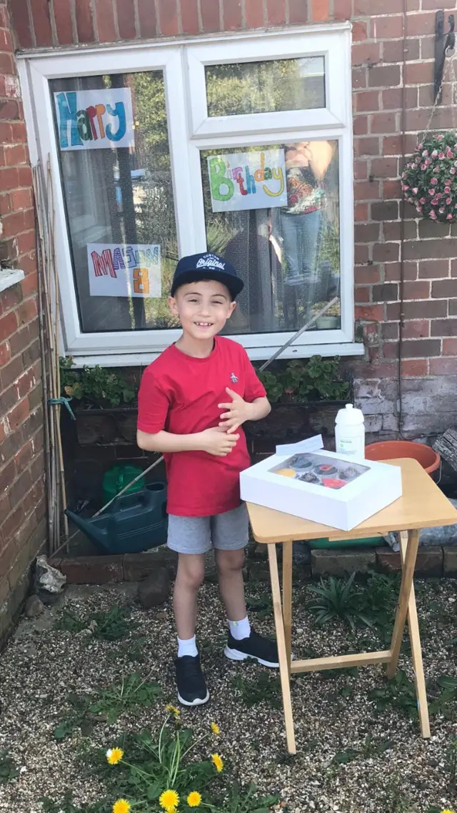 Mason with cakes that had been left out for him for his birthday