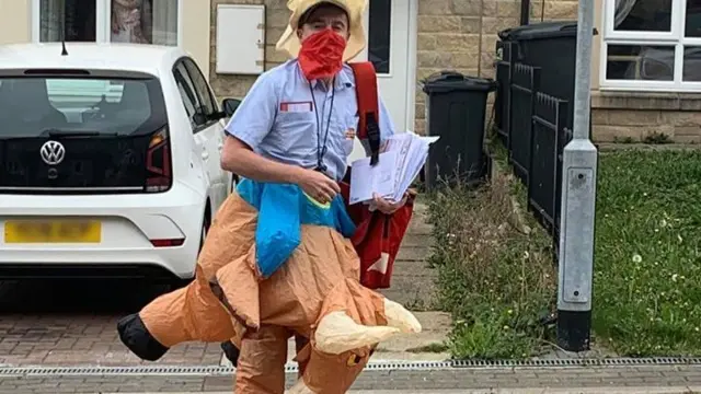 A postman in costume