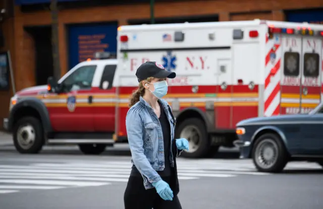 A person is seen wearing a protective face mask while walking in Gramercy Park