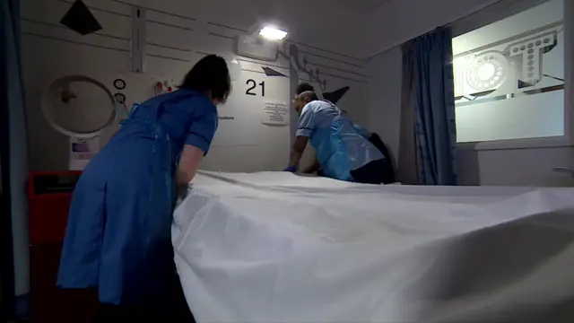 health workers making hospital bed