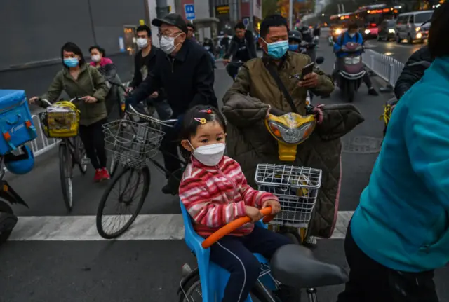 People travelling on bikes in Beijing