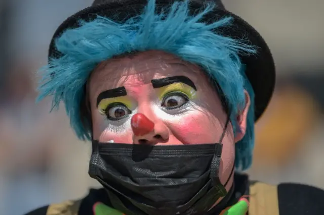 A clown wears a protective mask during a protest to demand Mexican government aid, Mexico City, on April 30, 2020