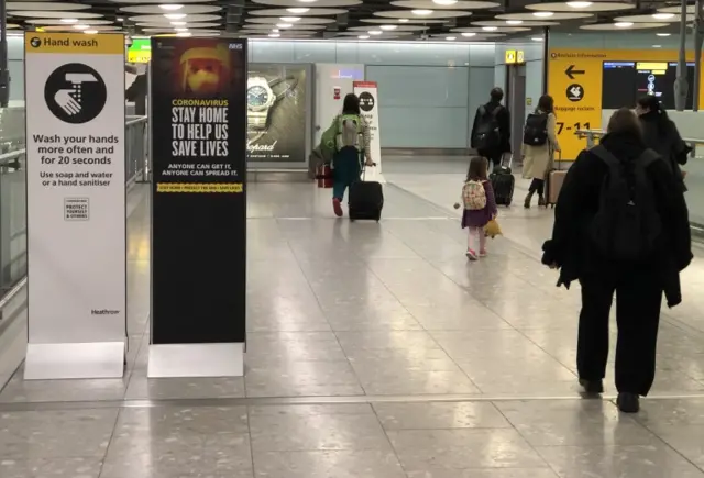 Signs asking people to stay at home in Terminal 5 at Heathrow Airport on April 15, 2020 in London