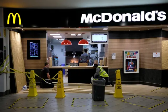 A McDonald's restaurant being boarded up as a result of the lockdown