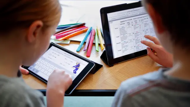 Children learning on tablets