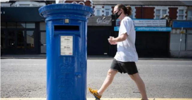 A postbox, near the University Hospital of Wales in Cardiff, painted blue in support of NHS staff