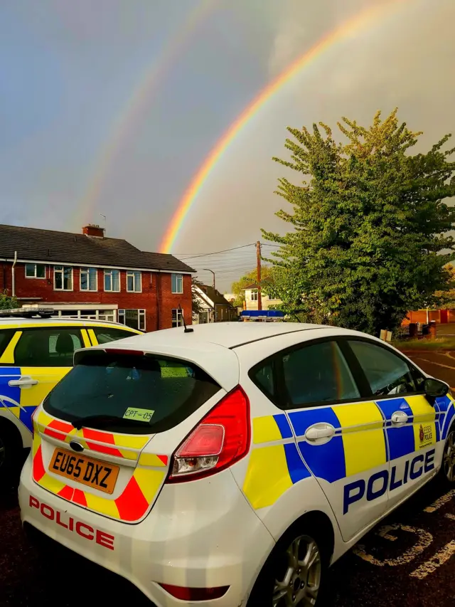 Rainbow over police car