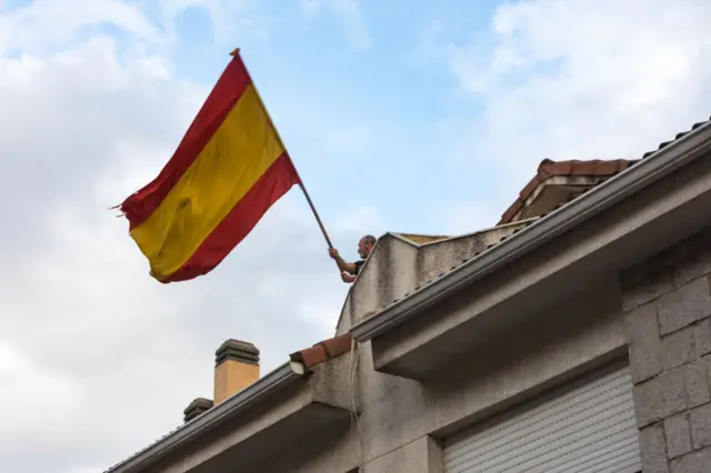 A man waves the Spain flag in Madrid