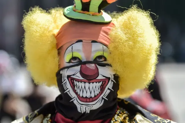 A clown wears a protective mask during a protest to demand Mexican government aid, Mexico City, on April 30, 2020