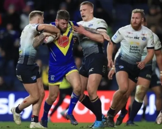 Leeds Rhinos' Mikolaj Oledzki and Matt Prior tackle Warrington Wolves' Daryl Clark