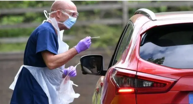 A medic tests a UK resident