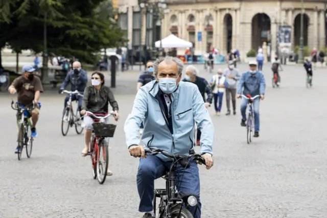 People ride bicycles outdoors on the first Sunday of Phase 2 during the coronavirus emergency, in Verona, northern Italy, 10 May 2020