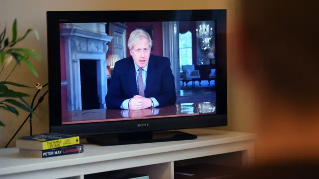 A person watching the prime minister's statement