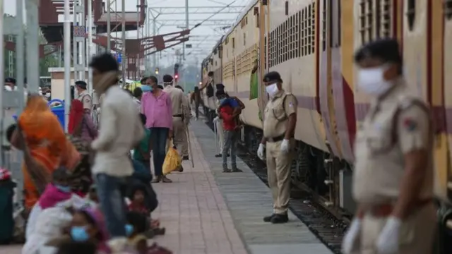 Train guards, wearing masks, and some passengers seen in file photo