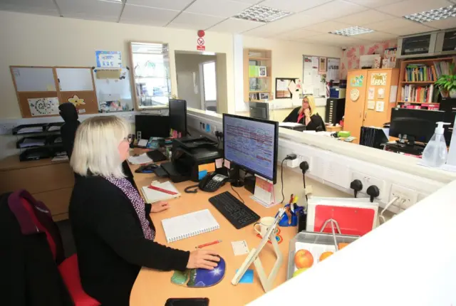 Office staff observe social distancing at work