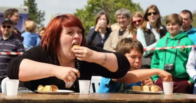 People taking part in knob-eating