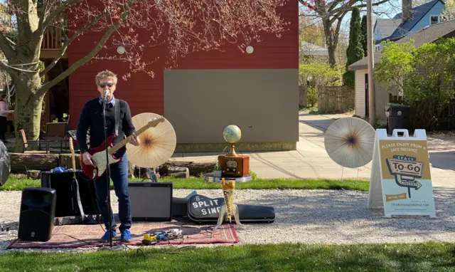 Jason Narducy playing a gig in a customer's front lawn