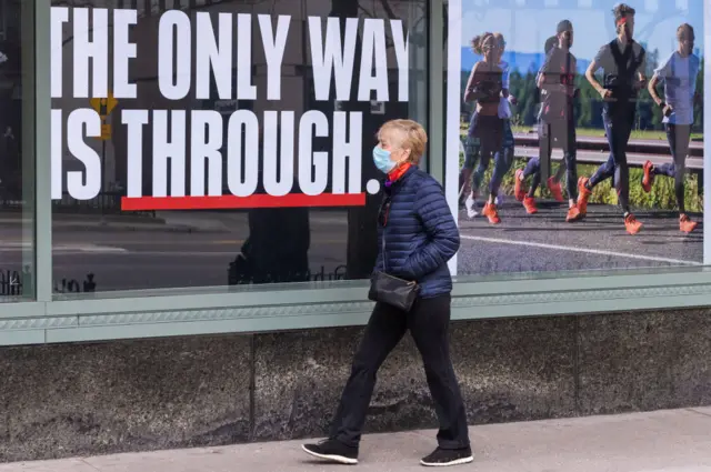 A woman walks on an abandoned Michigan Avenue in Chicago amid the coronavirus pandemic