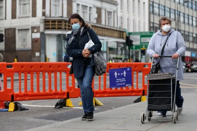 Women wear face masks in London