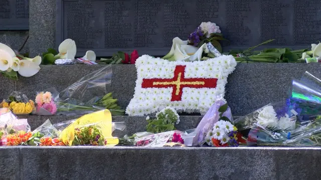 Wreath laid at Bailiwick War Memorial surrounded by flowers