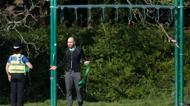 Police speaking to man in park