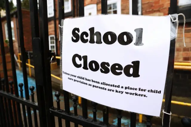 A sign on the gates of a closed school in the UK. File photo