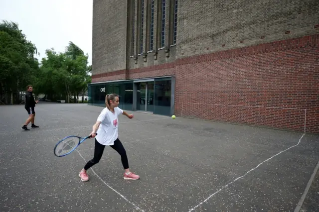 People play tennis against a wall of the Tate Modern building following the outbreak of the coronavirus disease (COVID-19), London, Britain 10 May 2020.