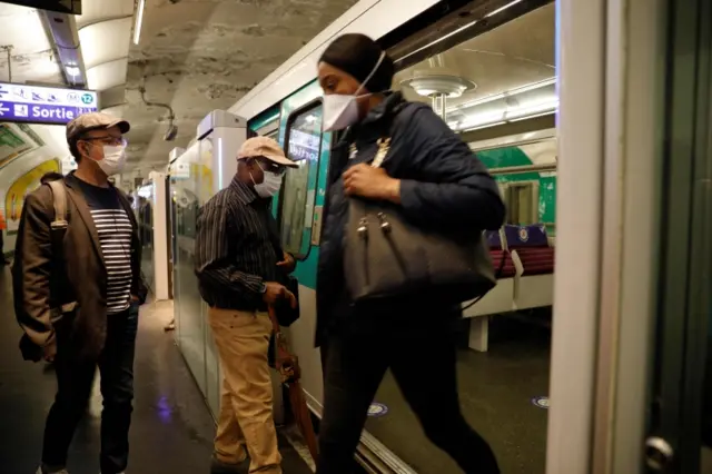 Commuters wearing face masks are seen at a metro station, on 11 May 2020 in Paris