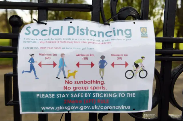 Social distancing guidance on park gates