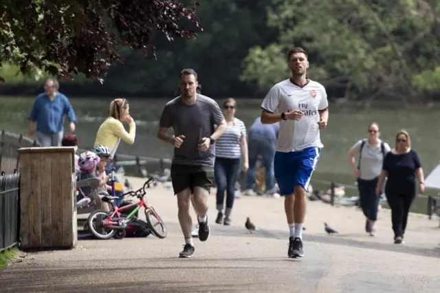 People walk and exercise in London's St James's Park. Photo: 10 May 2020