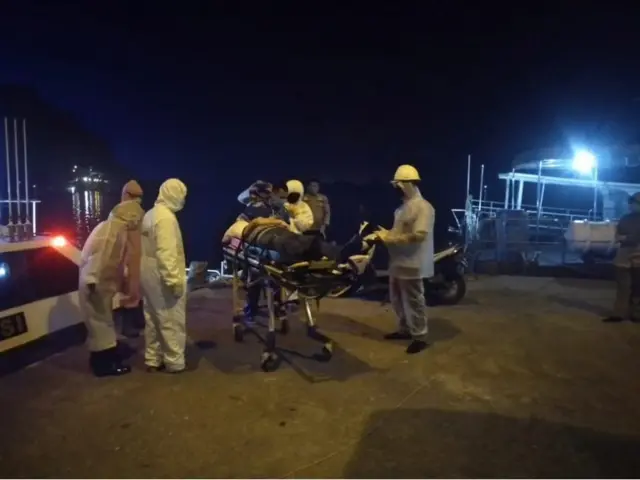 A seafarer being given medical assistance