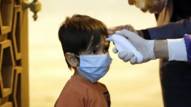 A boy is tested for coronavirus in Tehran, Iran. Photo: 12 May 2020