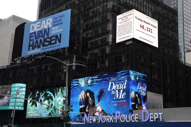 A 56-foot billboard called the "Trump Death Clock" is seen in Times Square in New York City on May 11, 2020.