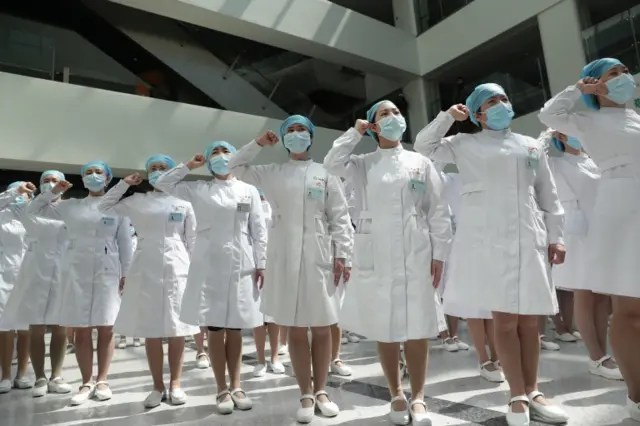 Nurses wearing face masks take part in an event held to mark International Nurses Day at Wuhan Tongji Hospital in Wuhan, China, on 12 May 2020.